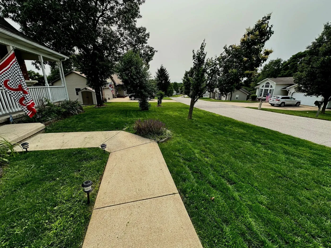 Freshly cut residential front lawn with a clean edge along the walk